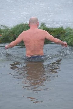 People Bathing in Ice Hole During Epiphany Ritual Stock Photos