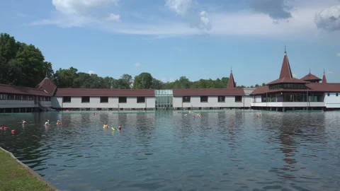People bathing outdoor in spa complex on thermal Heviz lake, Hungary - 4K Stock Footage 193539799