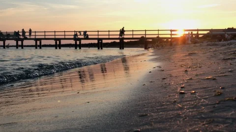 People an a bathing platform taking a bath in the sunset Stock Footage 93420242
