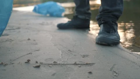 People on beach collects plastic trash,plastic bag.Water,beach pollution with Stock Footage 148808679