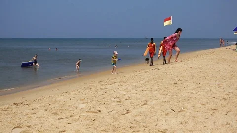 People on the beach with different activities. Calm sea, white sand. Stock Footage 83034589