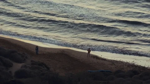 People on the beach during sunset Stock Footage 73904763