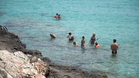 People at the beach Stock Footage 128348975