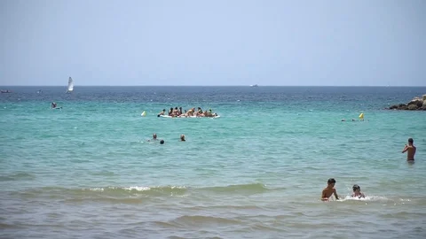 People at the beach Stock Footage 128349097