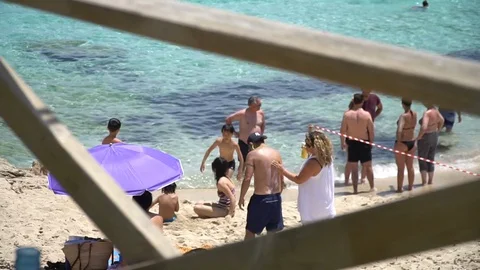 People at the beach medium shot Stock Footage 128348836