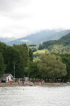People on the beach with mountains in the background Stock Photos