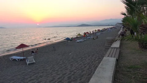 People on the beach one summer evening at the post covid times Stock Footage 138300737