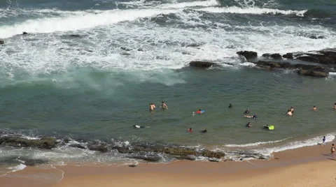 People in beach rock pool Stock Footage 33450166
