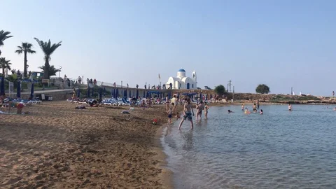 People At The Beach With Small Chapel At Background Stock Footage 112255762
