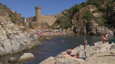 People at the beach in Tossa de Mar, Spain Stock Footage