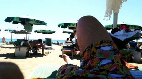 People on the beach under umbrellas Stock Footage 146907091