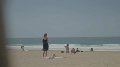 People on beach viewed from behind Stock Footage 342925277