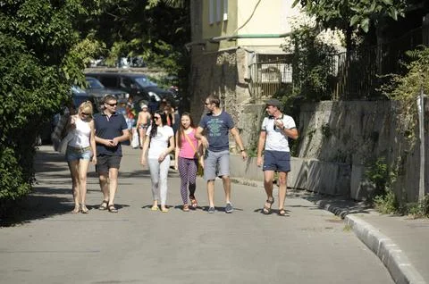 People beachgoers going down the old street of resort town Gurzuf. Crimea Stock Photos