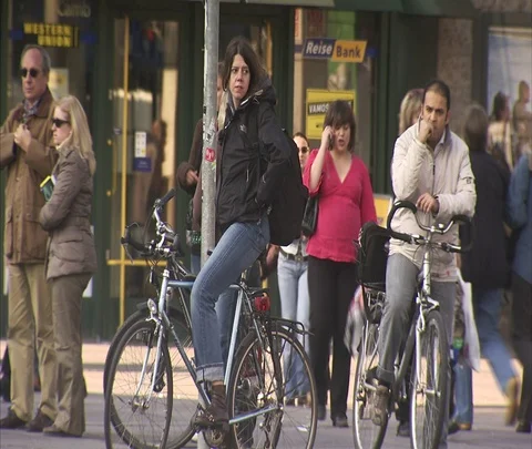 People on bicycles wait for traffic to pass. Stock-Footage 86742959