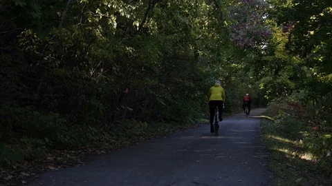 People on bikes pedal down trail Stock Footage 74070395