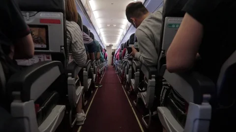 People board the plane on their runway. Stock Footage 116125320