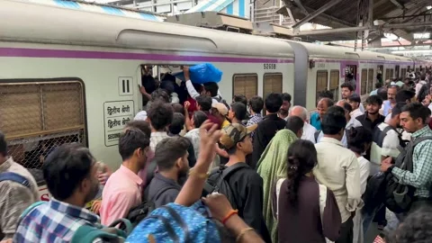 People boarding an crowded local train in Mumbai, India during rush hour Stock Footage 341455714