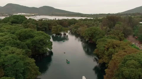 People boating on the clear river in Lago de Camecuaro, Camecuaro National Video stock 336604986