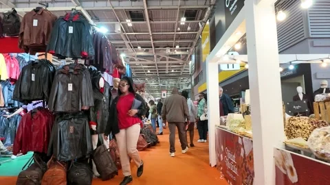 People Browsing Moroccan Nougat and Leather Jackets at a Paris Indoor Market Stockbeeldmateriaal 334833976