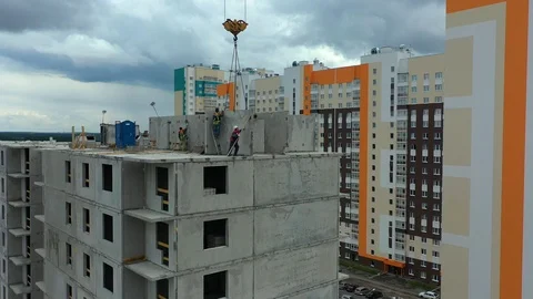 People builders are installing a ceiling on the top floor of building building Stock Footage 113567706