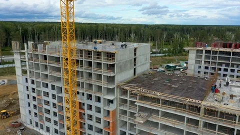 People builders are installing a ceiling on the top floor of building building Stock Footage 113932414