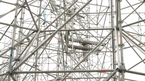 People building a massive structure out of steel pipes - 50fps Stock Footage 34304353