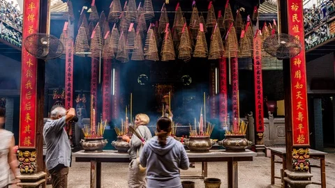 People burning incense at Ba Thien Hau pagoda, Ho Chi Minh City, Vietnam Stock Footage 116860005