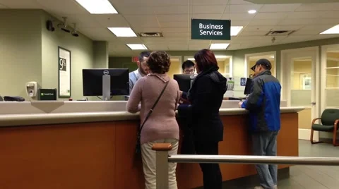 People at business service counter talking to the teller Stock Footage 44123798