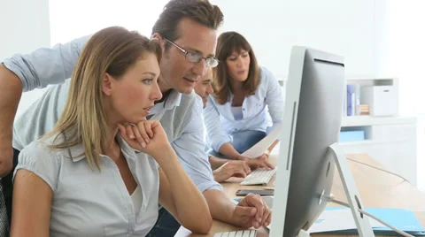 People in business training working on desktop computer Stock Footage