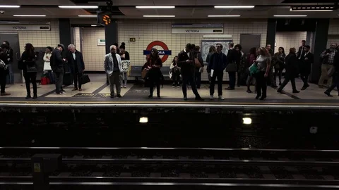 People on busy platform at underground train station in London Stock Footage 98540205