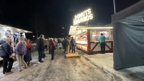 People buyers waiting in queue outside Donuts Churros shop street vendor arctic Stock Footage 302377462