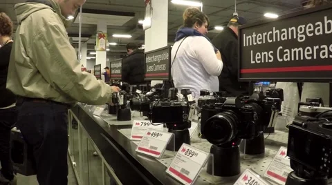 People buying new camera inside future shop Stock Footage 45706358