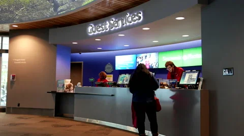 People buying ticket at guest service counter inside Vancouver aquarium Stock Footage