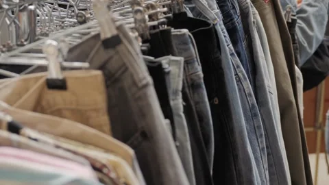 People buying used second hand clothes outdoor. Charity Shop and Garage Sale Видео 270484164
