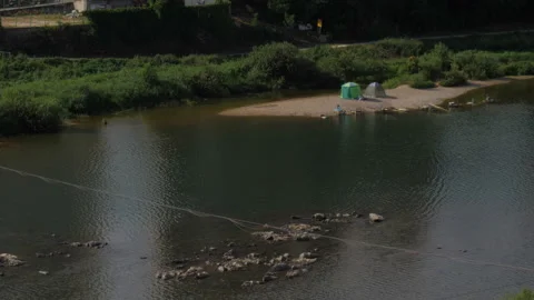 People camping in the river Stock Footage 94011807