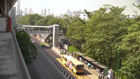 People can be seen going to Chatuchak weekend market by bus or BTS skytrain. 動画素材 318124997