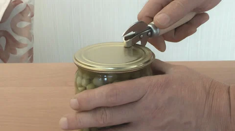 People can opener opens the jar of peas Stock Footage 39908047
