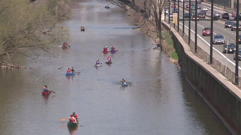 People canoeing down the don river in the city of Toronto on a sunny spring day Stock Footage 49728959