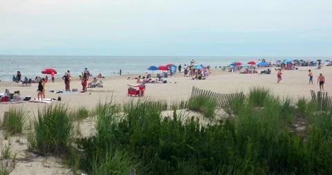 People at Cape May beach during summer season, Atlantic ocean, NJ - 4K Stock Footage 246975464