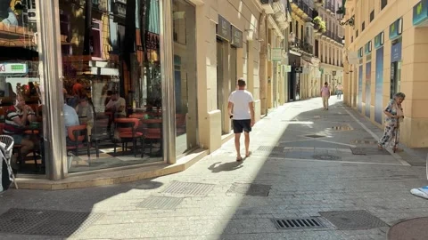 People casually walking through Malaga Stock Footage 338271030