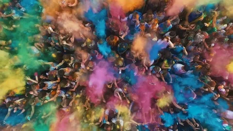 People celebrating holi festival throw colors to each other aerial view Stock Footage
