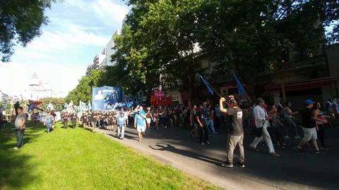 People chanting and clapping while marching in a protest with shadow - 24fps Stock Footage 104033573