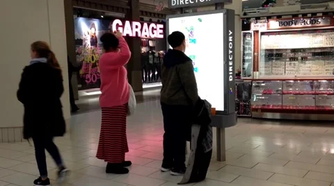 People checking direction map inside shopping mall Stock Footage 54224267