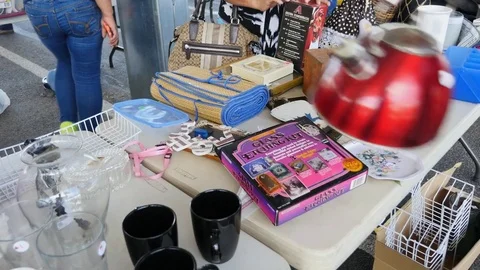 People checking out items at a rummage sale Stock Footage 75358517