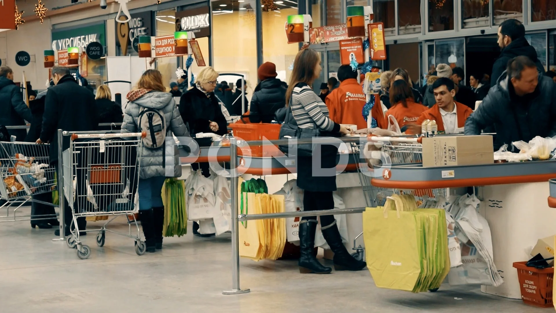 People on checkout counter in Auchan hypermarket