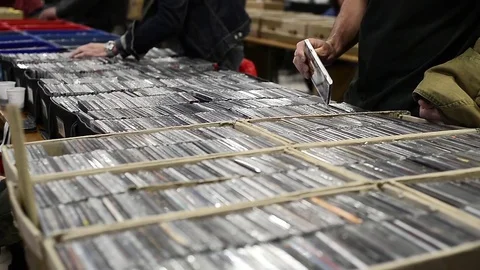 People choose old compact disc at a vinyl fair in Turin, Italy Stock Footage 76147011