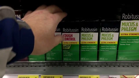 People choosing Robitussin cough control at pharmacy section Video stock 73971925