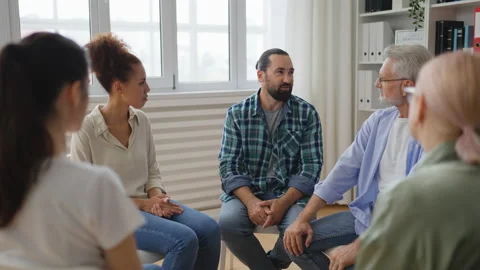People clapping hands, encouraging middle-aged man during support group meeting Stock Footage 232294931