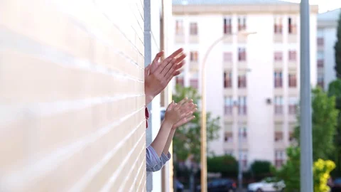 People clapping in the window in support of people against the coronavirus Stock Footage 128313397