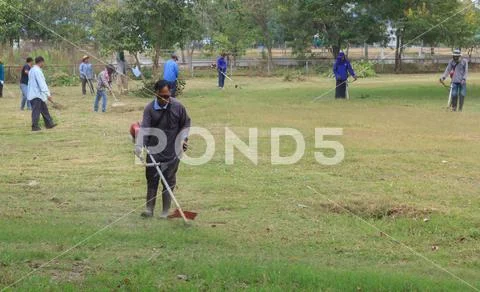 People clean the grounds of government offices.Mahasarakham,Thailand,December Stock Photos